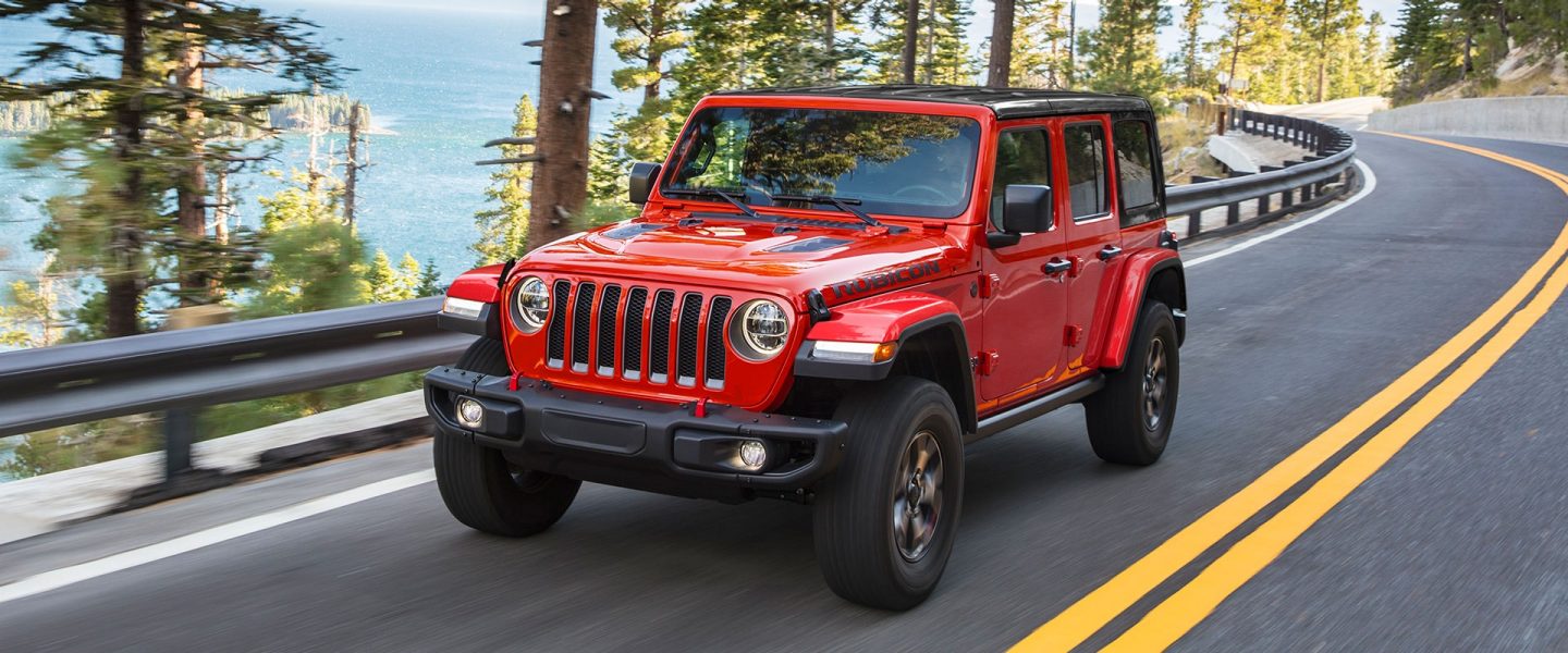 The 2021 Jeep Wrangler Rubicon being driven past a lake.